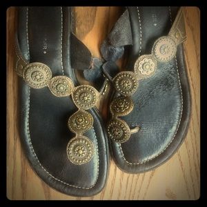 Cute brown, leather sandals with brass detailing.